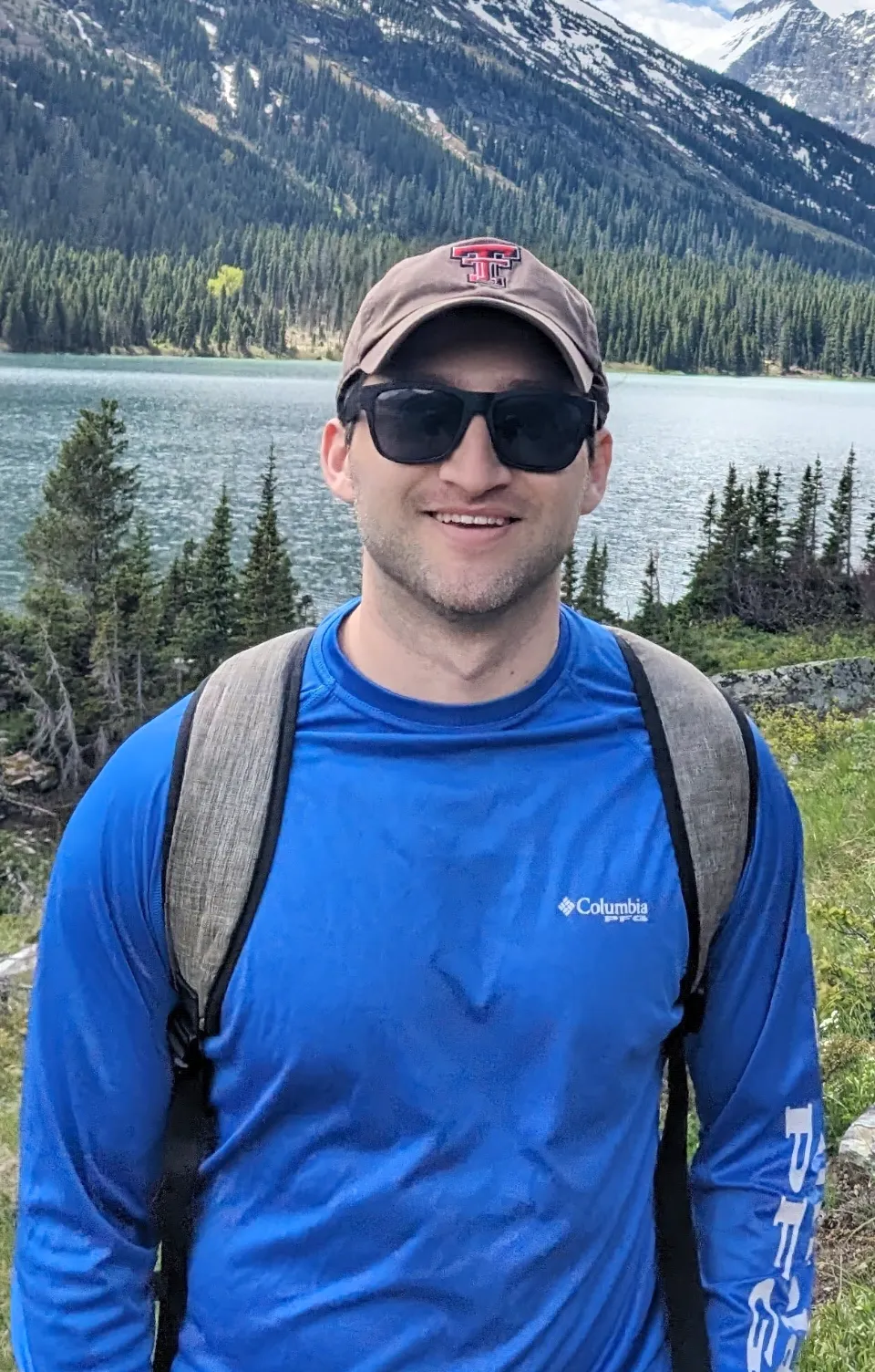 Gerard Fierro smiling outdoors in front of a mountain lake